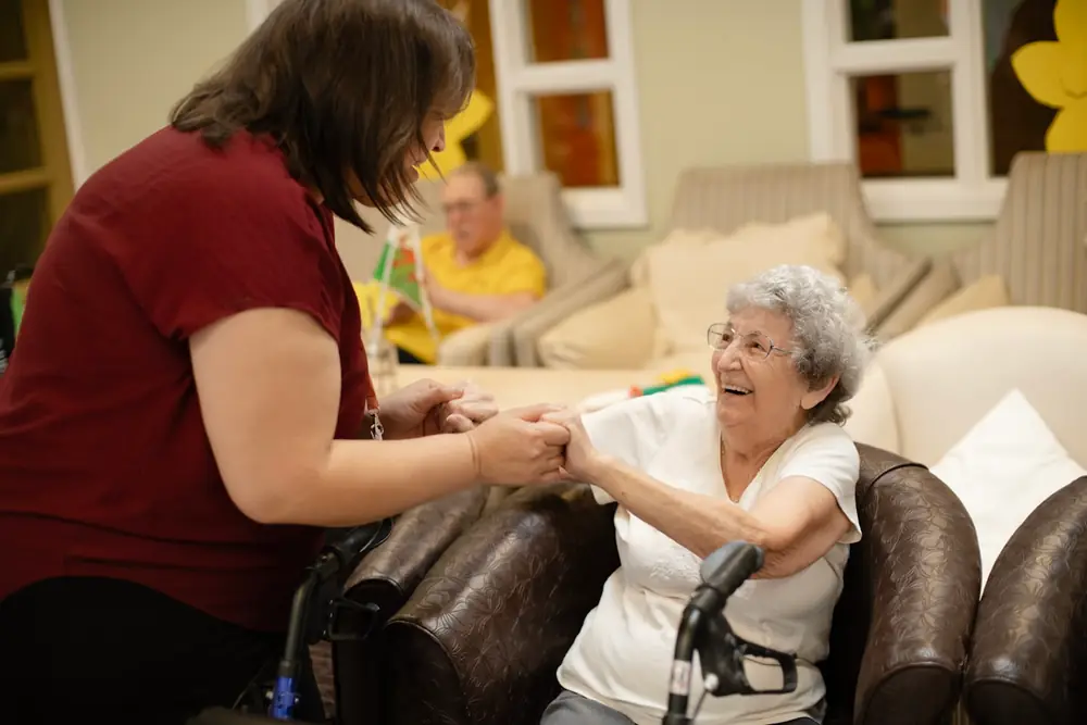 A carer helping an elderly woman at home